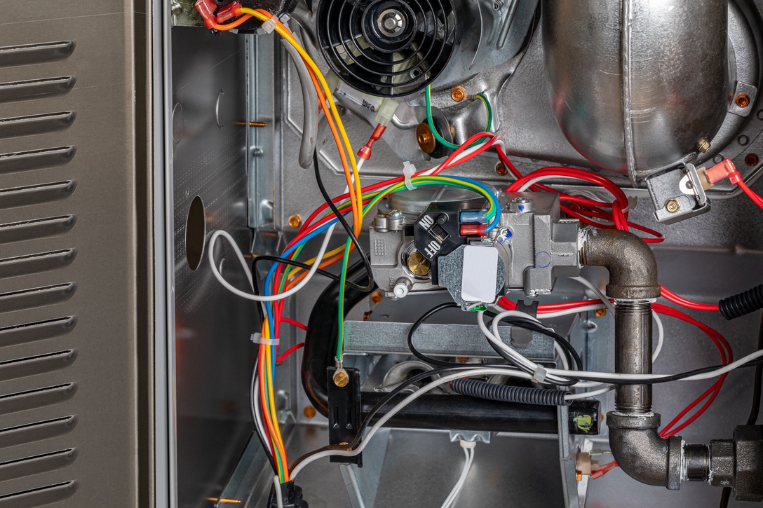 Access panel of natural gas furnace open to demonstrate maintenance requirements