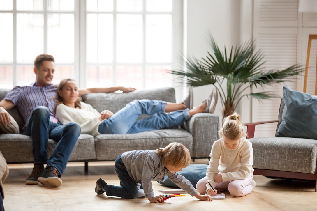 Happy family in living room of multi-zone home