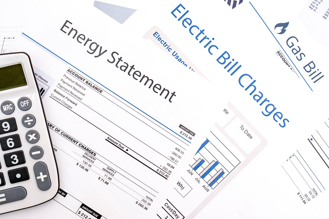 Electric and gas bills to symbolize increasing energy usage from inefficient old furnace